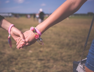 red and pink floral bracelet holding hands thumbnail